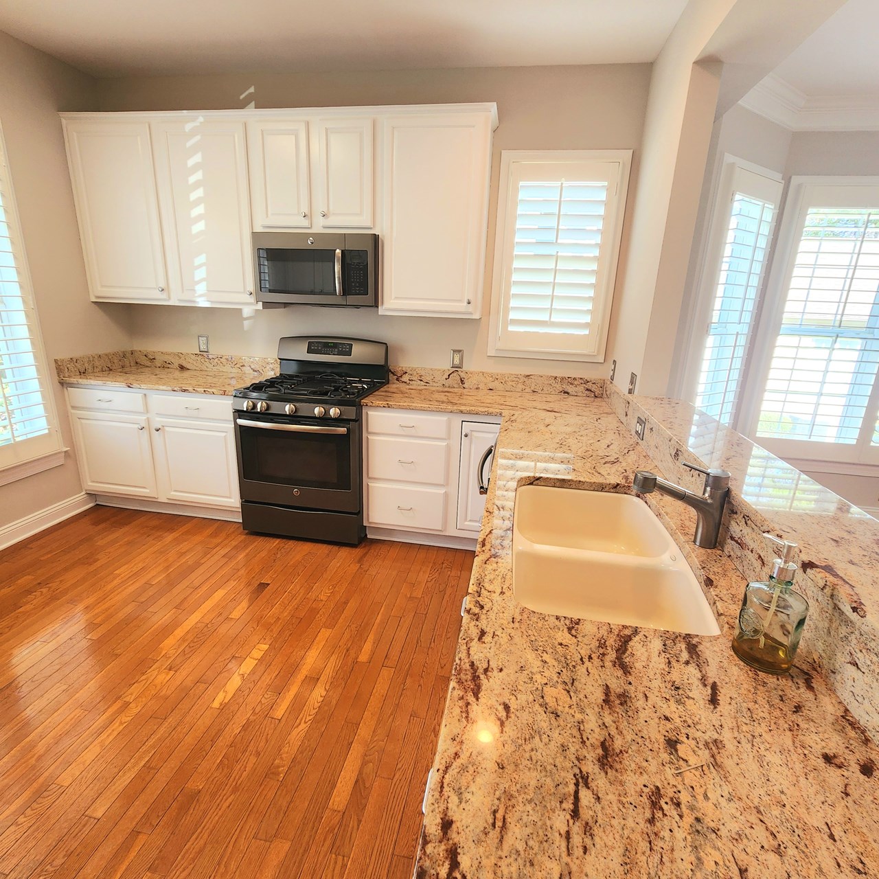 roomy kitchen with granite and gas range