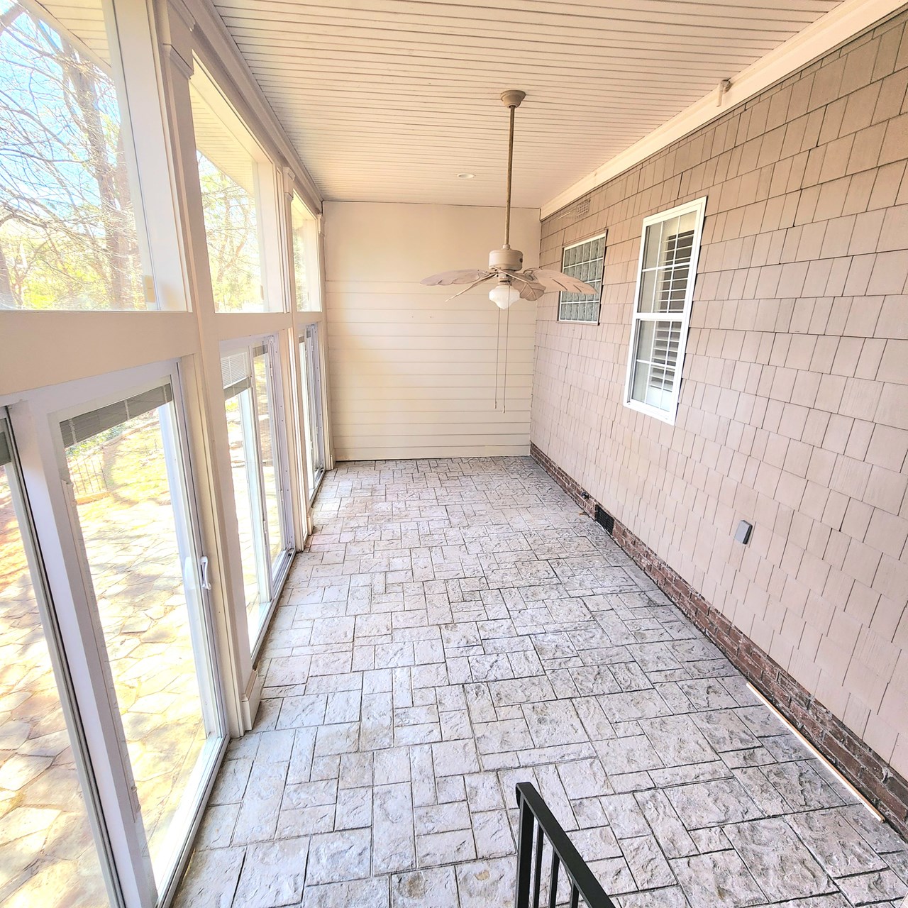 enclosed patio with sliding glass and screen doors.