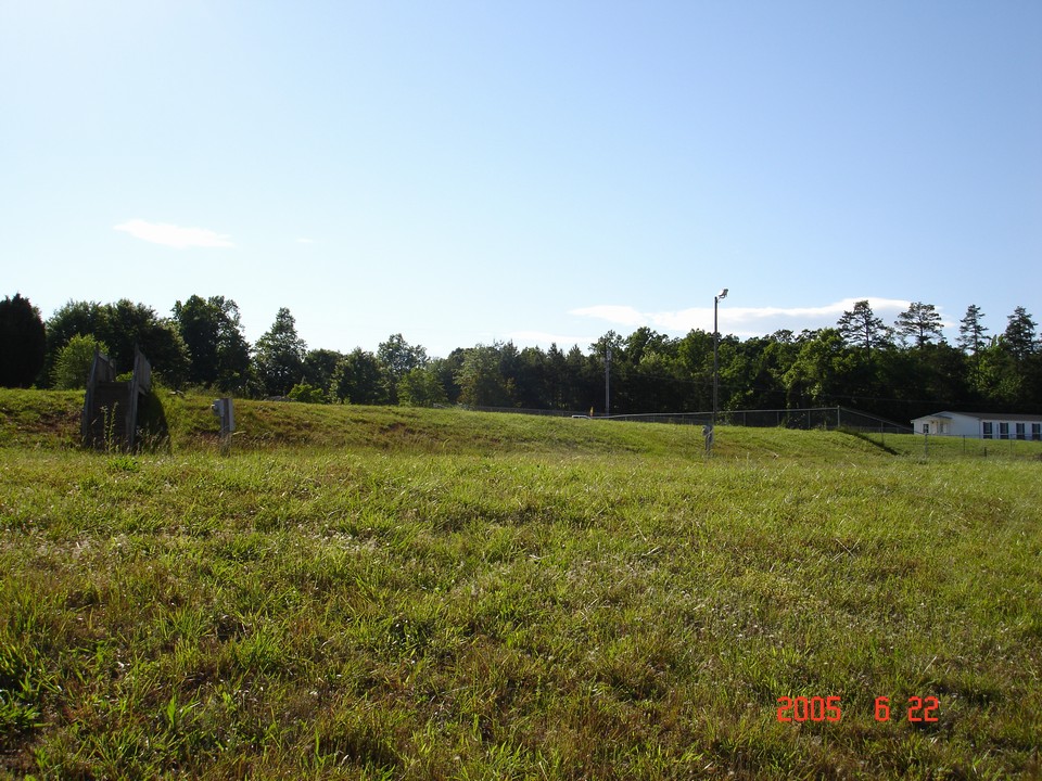 photo of property - a car dealership  is currently operating on property next door. property has a 6 inch water connection on property.  sewer is located across the street.  property has been rezoned to general business conditional use.  ncdot has approved a driveway permit for this property.